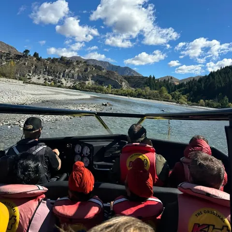 A jet boat carrying passengers along the Shotover River