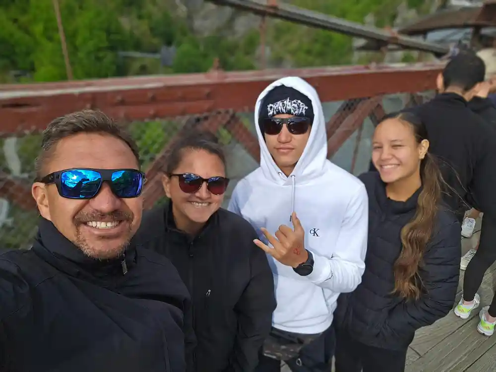 Four people posed together on the bridge before jumping