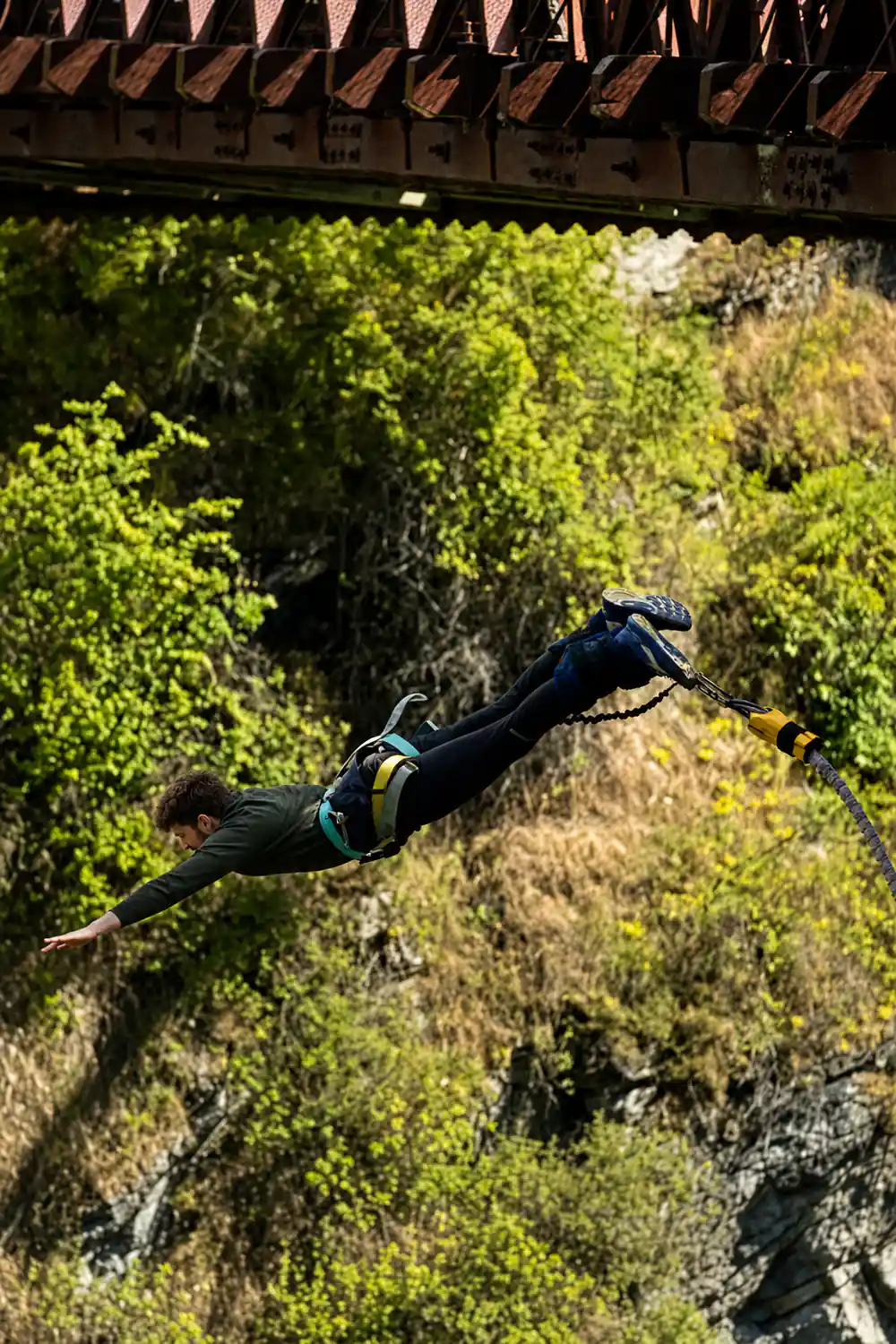 A jumper falling upside down beneath the bridge ironwork