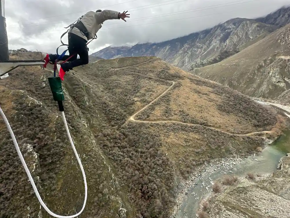 A jumper leaving a platform above a dry canyon at the operator other site