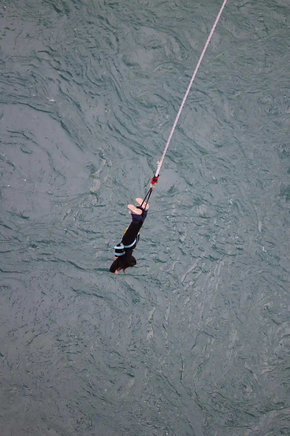 A jumper seen from above against grey braided water