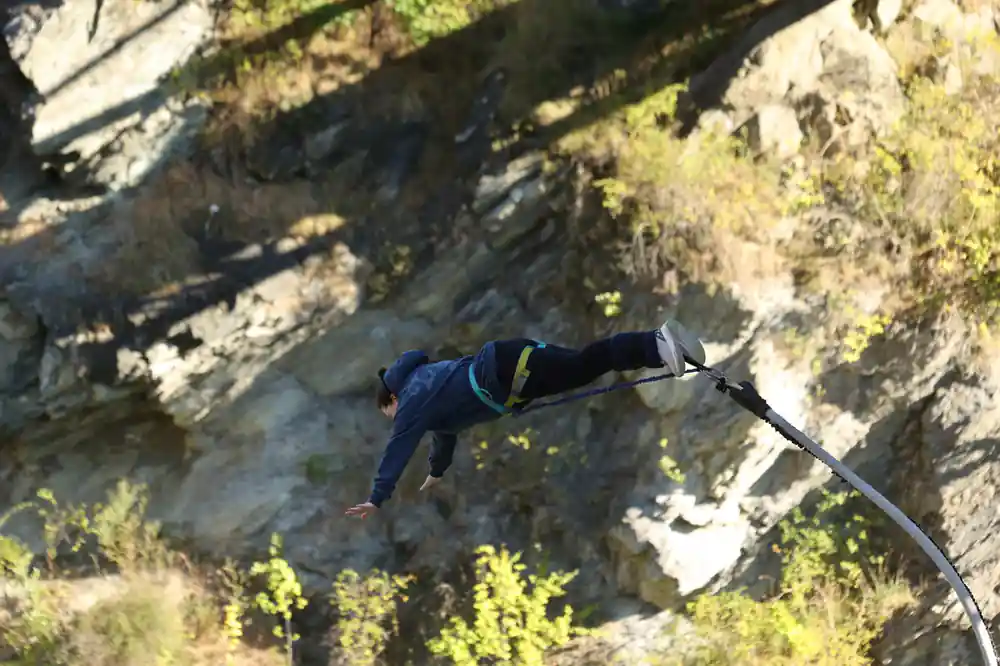 A jumper stretched out horizontally against the canyon wall