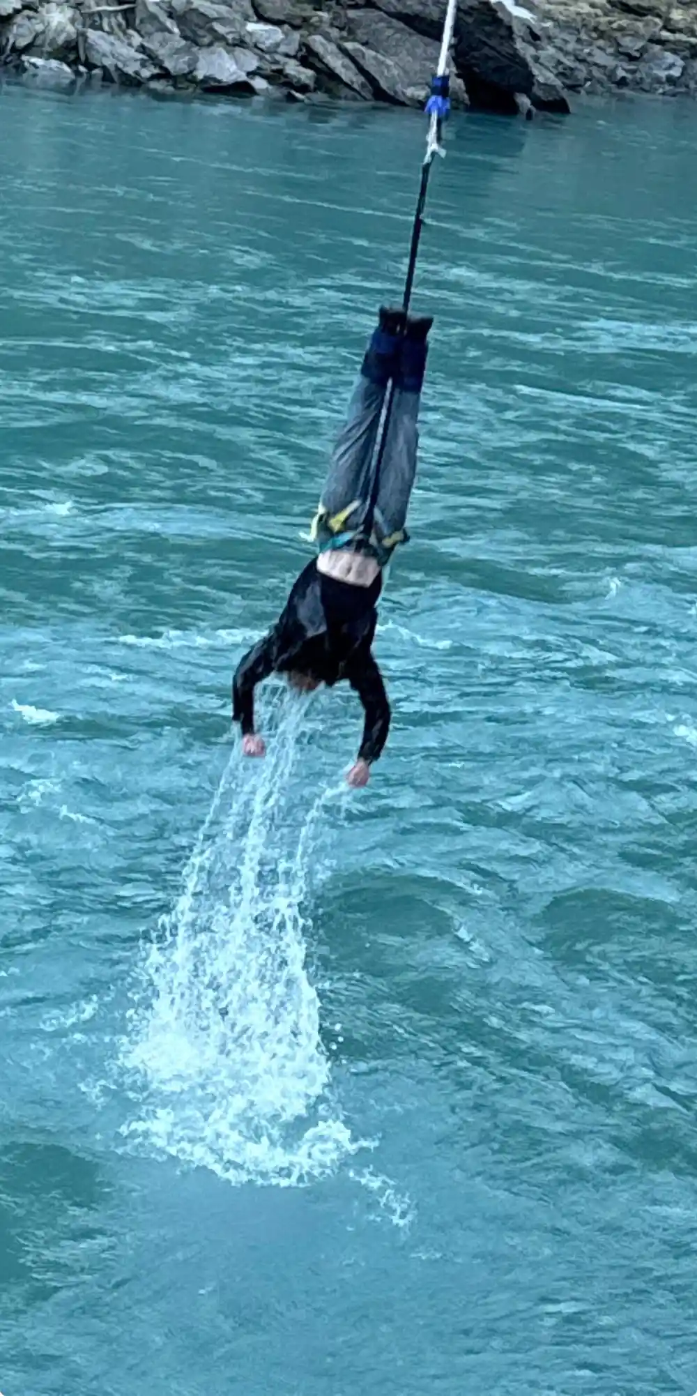 A jumper touching the surface of the river and throwing up spray